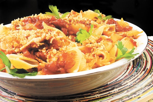 O molho de tomates envolve a massa e lhe confere aroma e sabor específicos, complementados pela farofa frita de pão a que os italianos chamam “molicca”